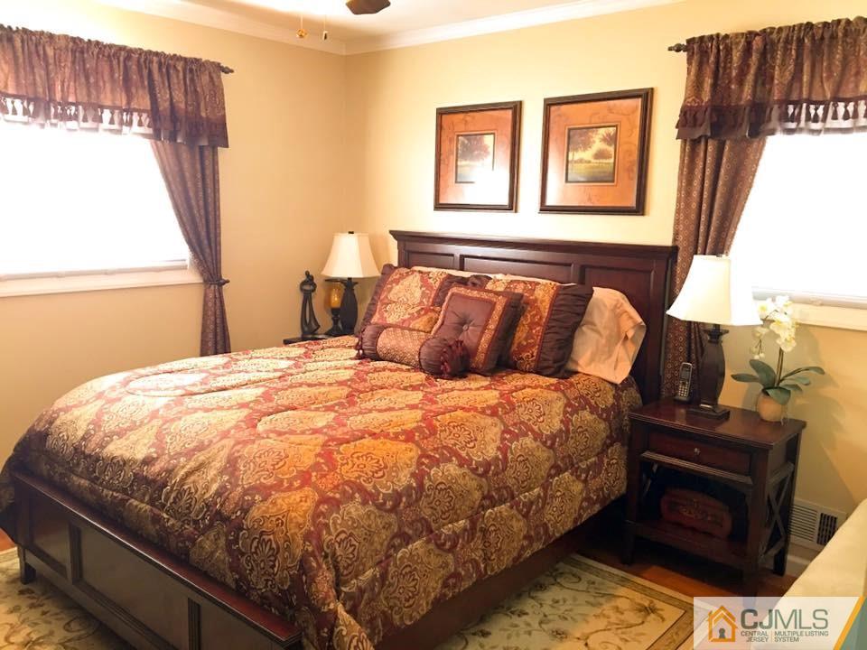 17 Wilshire Road Edison, NJ 08817 - Photo 6 of 19 a bed sitting in a bedroom next to a window
