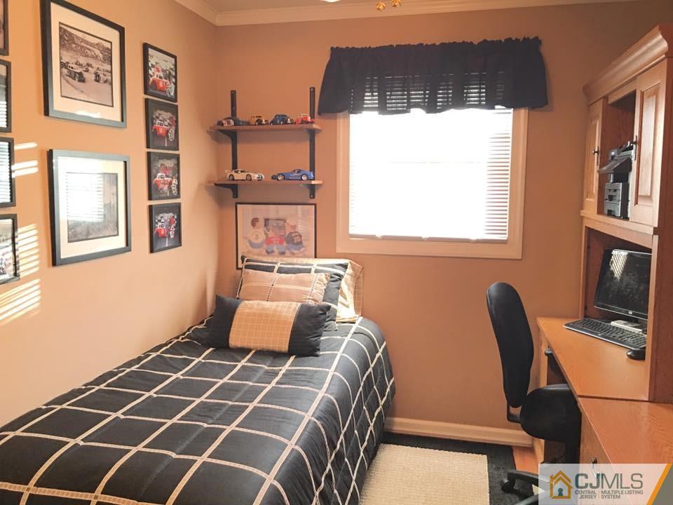 17 Wilshire Road Edison, NJ 08817 - Photo 8 of 19 a bedroom with a bed and a window