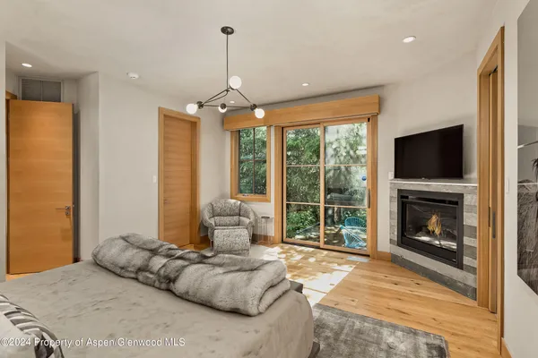 a bedroom with a bed and a fireplace