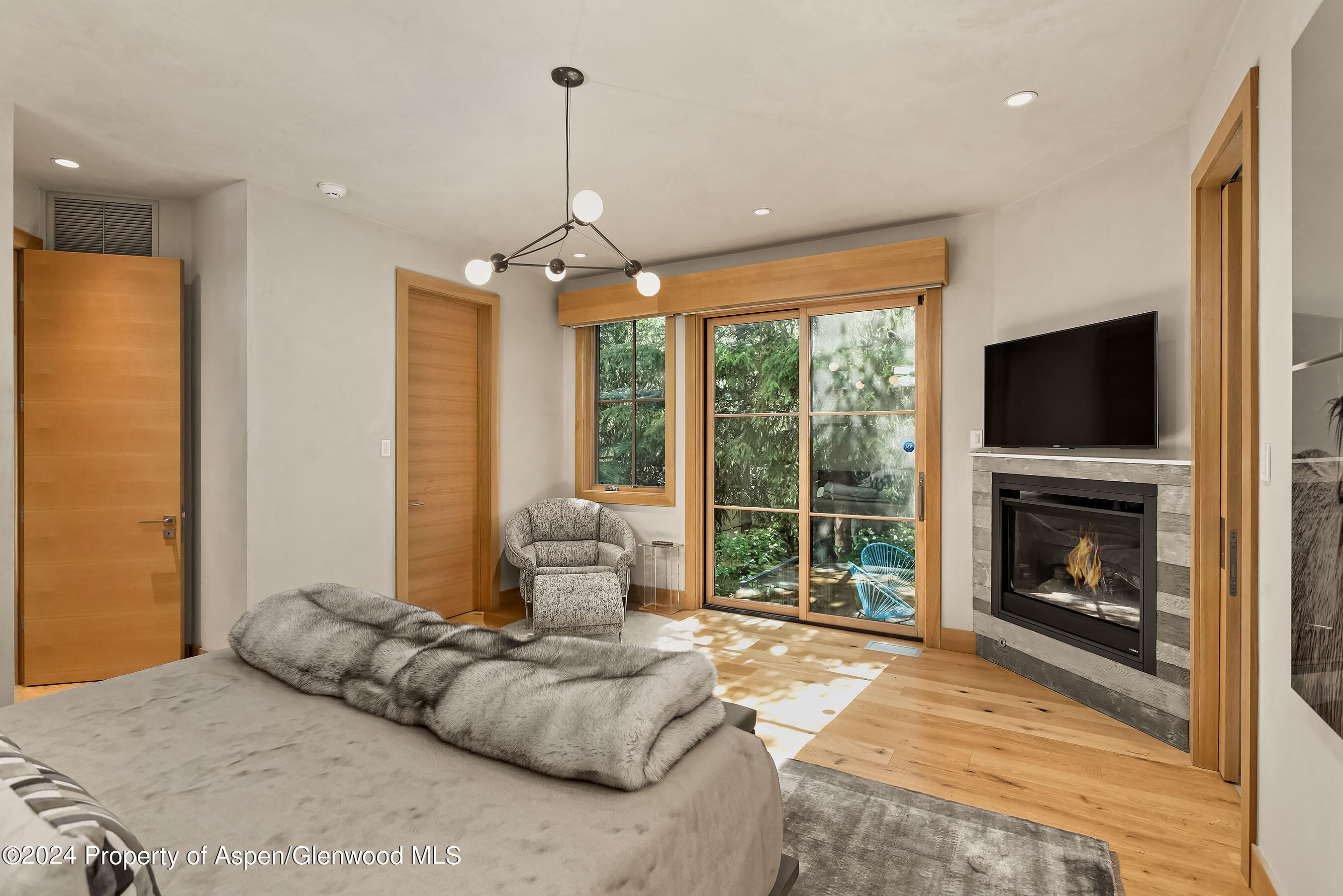 1190 Riverside Drive Aspen, CO 81611 - Photo 13 of 31 a bedroom with a bed and a fireplace