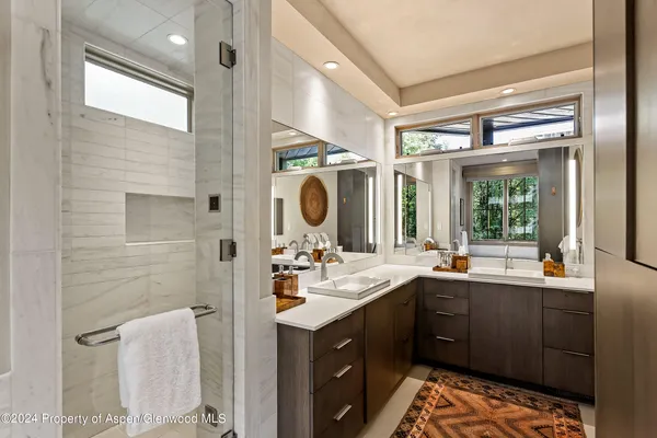 a bathroom with a sink double vanity and a mirror