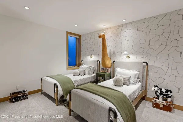 a bedroom with two beds and a lamp