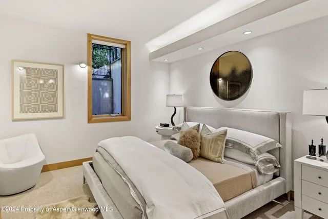 a bedroom with 2 bed and a window