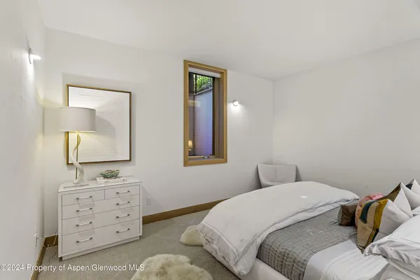 a bedroom with a bed and a mirror