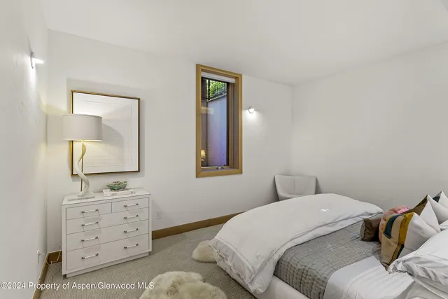 a bedroom with a bed and a mirror