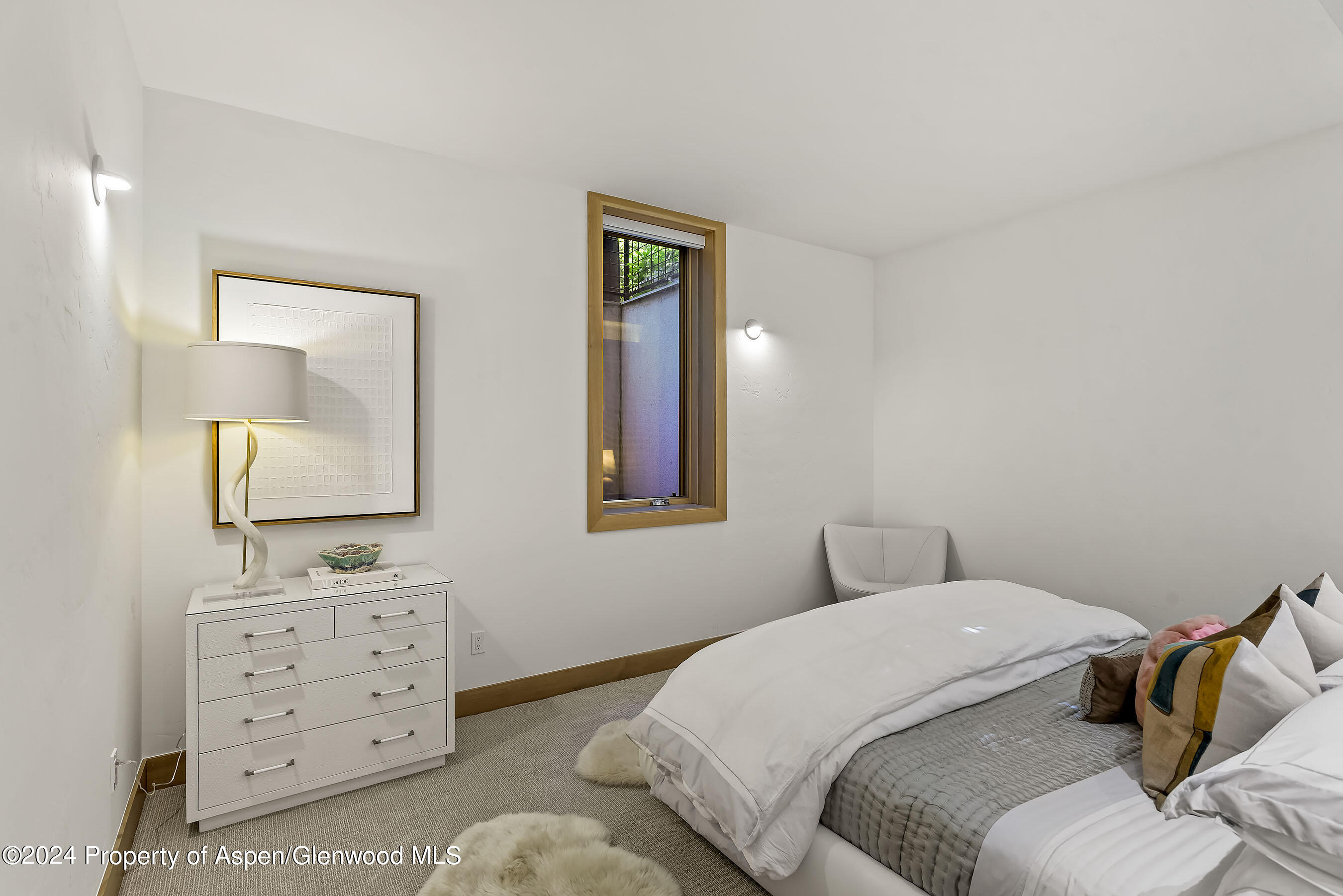 1190 Riverside Drive Aspen, CO 81611 - Photo 21 of 31 a bedroom with a bed and a mirror