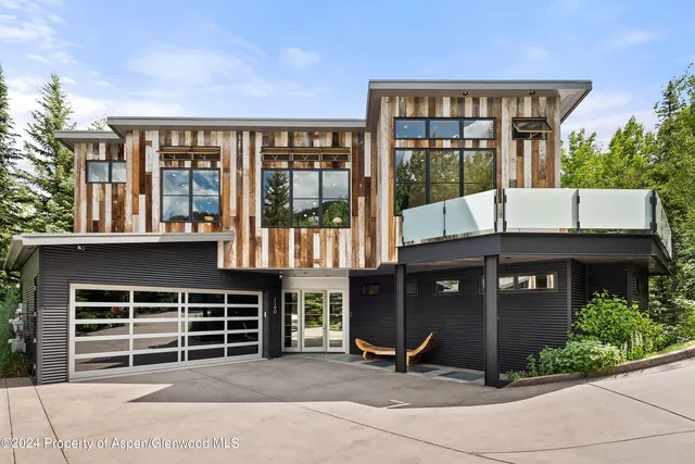 a front view of a house with a parking space