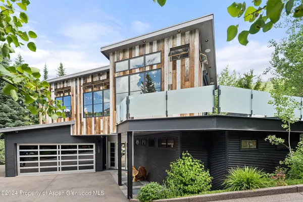 a front view of a house with plants