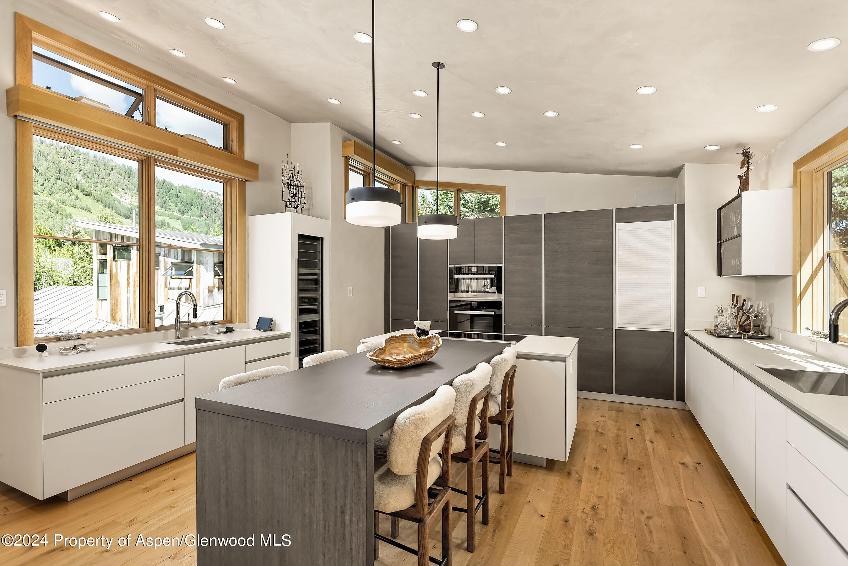 1190 Riverside Drive Aspen, CO 81611 - Photo 8 of 31 a kitchen with a table chairs refrigerator and cabinets