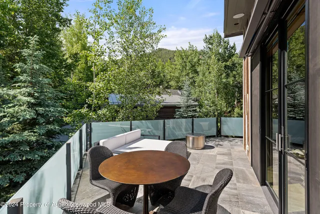 a balcony with table and chairs