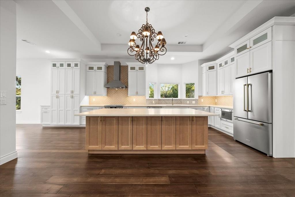 3801 Berry Hill Court Double Oak, TX 75028 - Photo 11 of 33 a kitchen with stainless steel appliances granite countertop a refrigerator a sink dishwasher a stove and white cabinets with wooden floor
