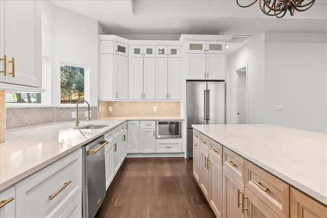 a large kitchen with a large window and a refrigerator