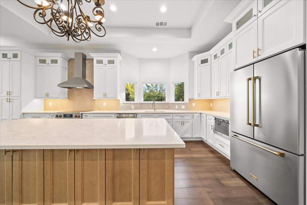 3801 Berry Hill Court Double Oak, TX 75028 - Photo 13 of 33 a kitchen with stainless steel appliances granite countertop a refrigerator a sink dishwasher and white cabinets with wooden floor