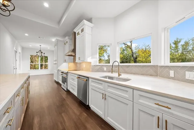 a kitchen with a stove oven and sink
