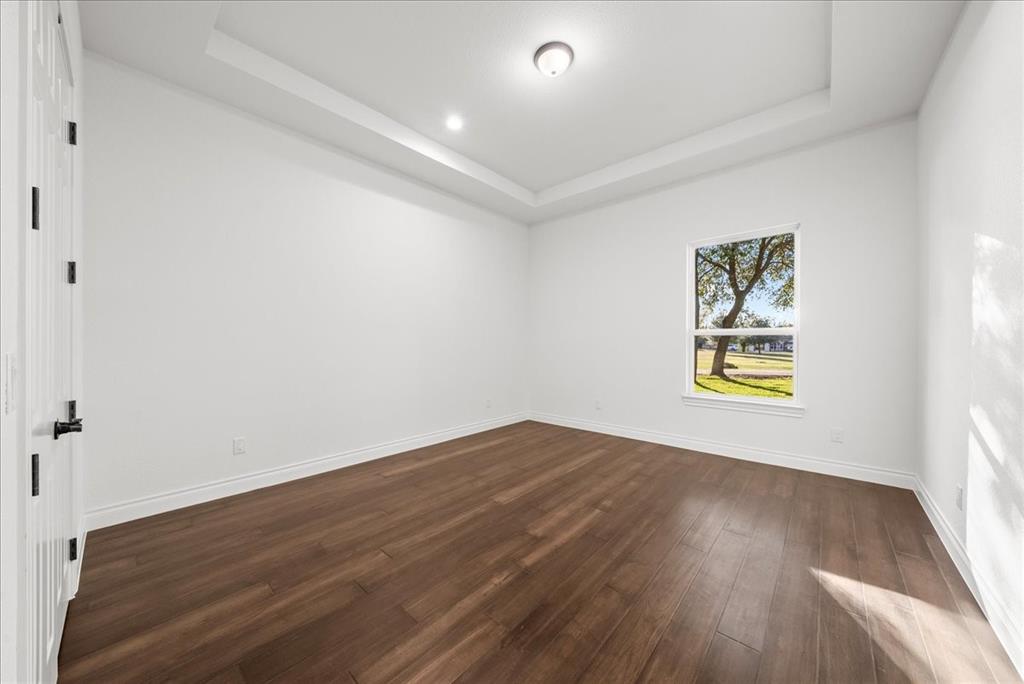 3801 Berry Hill Court Double Oak, TX 75028 - Photo 19 of 33 an empty room with wooden floor and window