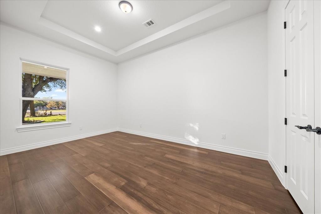 3801 Berry Hill Court Double Oak, TX 75028 - Photo 21 of 33 an empty room with wooden floor and windows