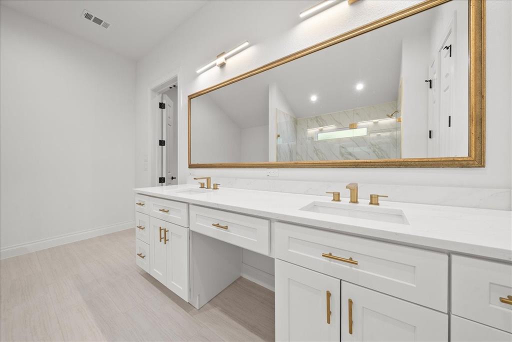 3801 Berry Hill Court Double Oak, TX 75028 - Photo 22 of 33 a bathroom with a sink and a mirror