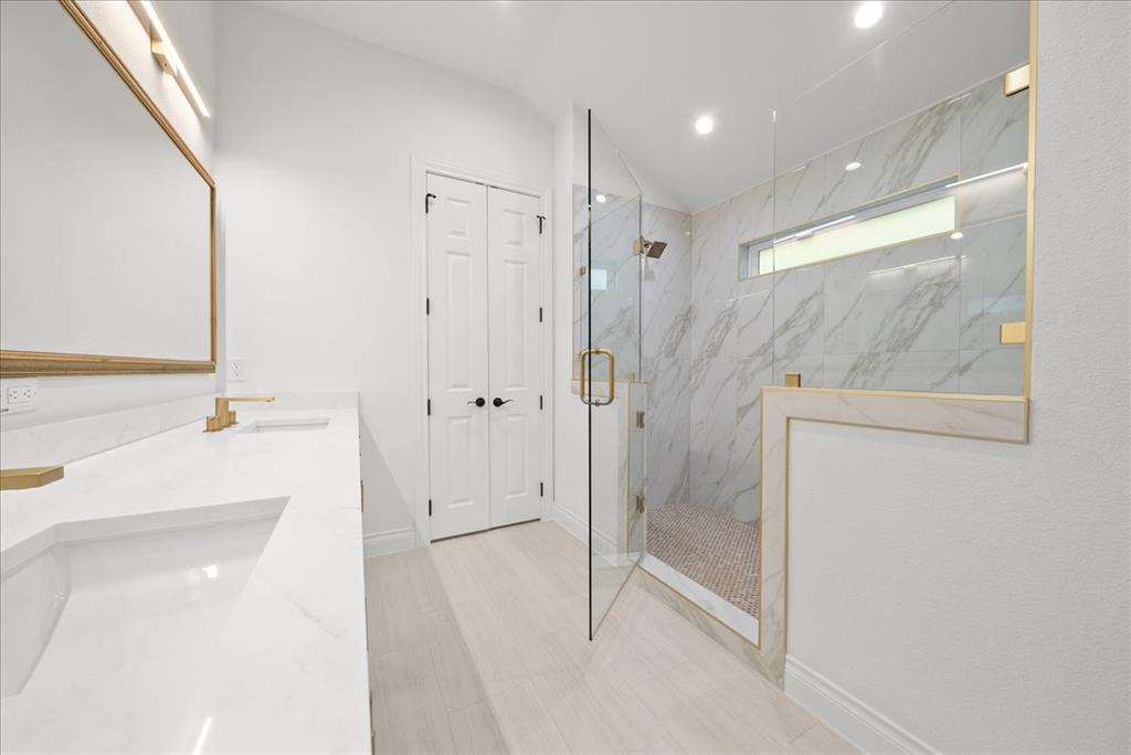 3801 Berry Hill Court Double Oak, TX 75028 - Photo 23 of 33 a bathroom with a bathtub and a shower