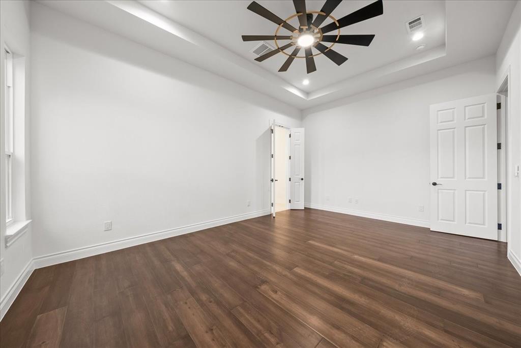 3801 Berry Hill Court Double Oak, TX 75028 - Photo 26 of 33 an empty room with wooden floor and windows