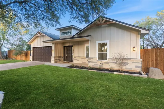 a front view of house with yard and green space