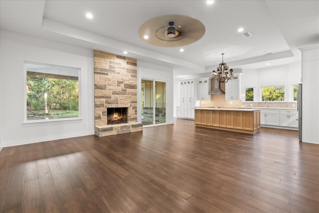 3801 Berry Hill Court Double Oak, TX 75028 - Photo 6 of 33 an empty room with wooden floor fireplace and windows