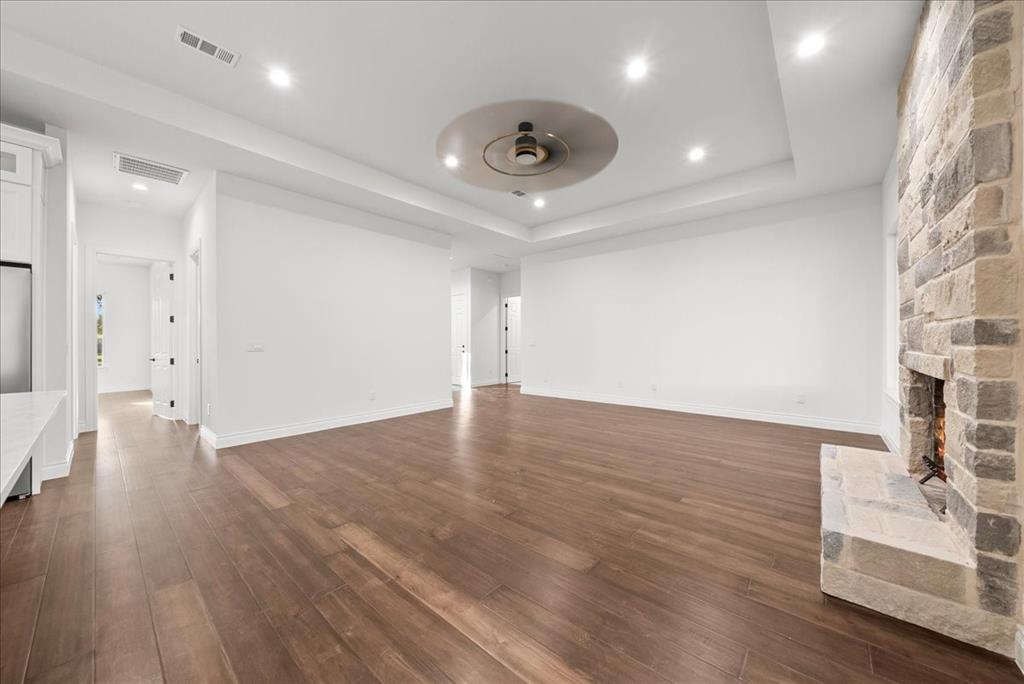 3801 Berry Hill Court Double Oak, TX 75028 - Photo 9 of 33 a view of an empty room with wooden floor and a window