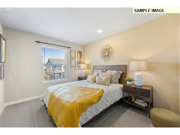 224 North 89th Loop, Unit 85 Ridgefield, WA 98642 - Photo 24 of 32 a bedroom with a bed and a night stand