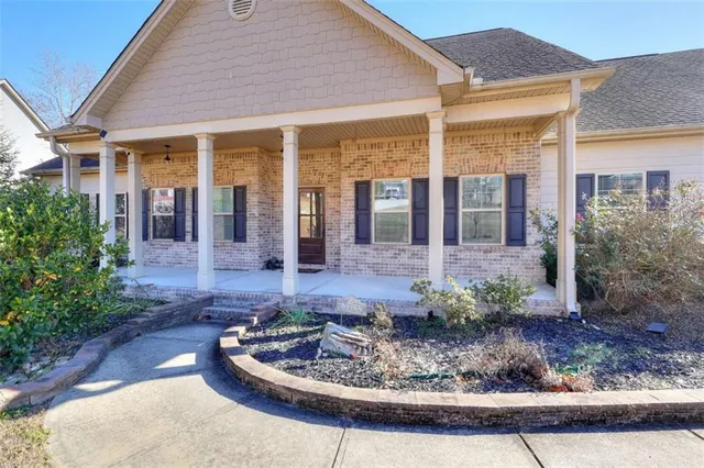 a front view of a house with porch yard and outdoor seating
