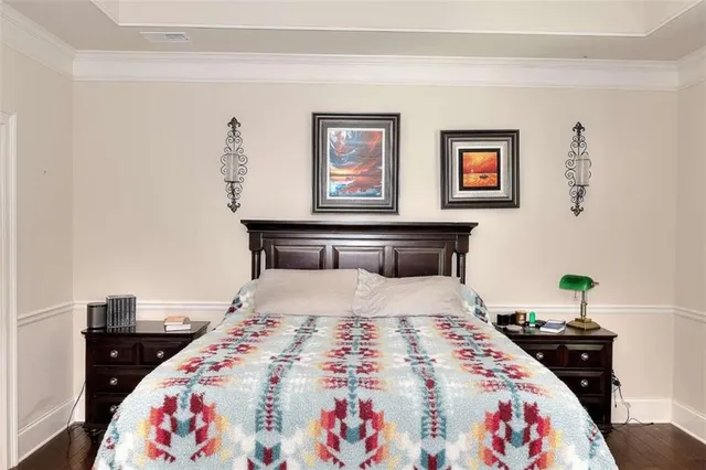 a bedroom with bed and wooden floor