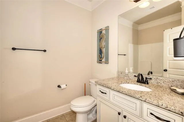 a bathroom with a granite countertop sink a toilet and a mirror