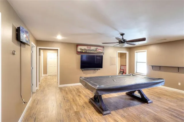 a workspace with wooden floor and a bookshelf