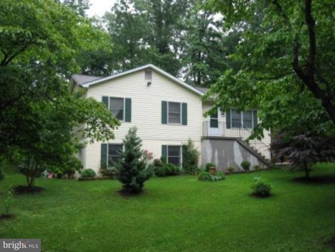 11456 Rawhide Road Lusby, MD 20657 - Photo 1 of 10 a view of a house with backyard and garden