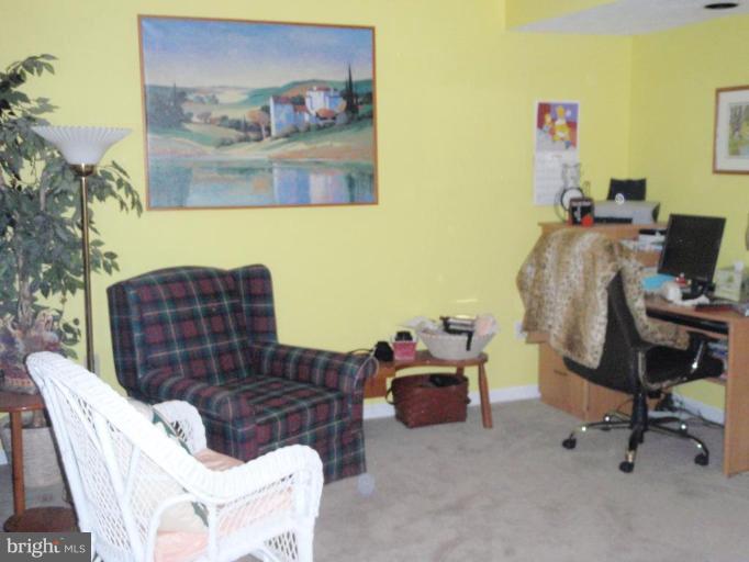11456 Rawhide Road Lusby, MD 20657 - Photo 3 of 10 a workspace with furniture and a couch