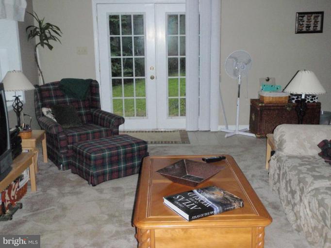 11456 Rawhide Road Lusby, MD 20657 - Photo 4 of 10 a living room with furniture and a flat screen tv