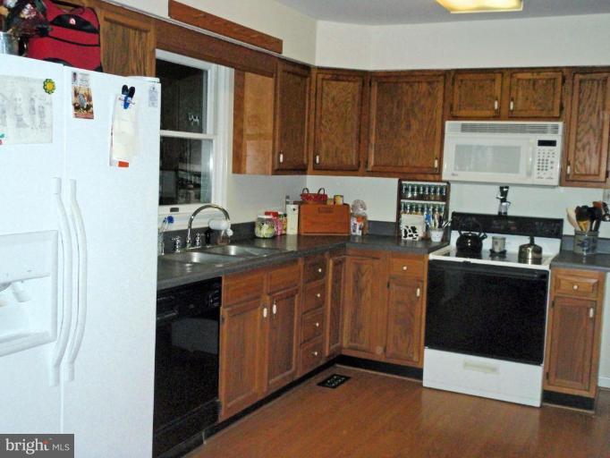 11456 Rawhide Road Lusby, MD 20657 - Photo 6 of 10 a kitchen with stainless steel appliances granite countertop a refrigerator and a stove top oven