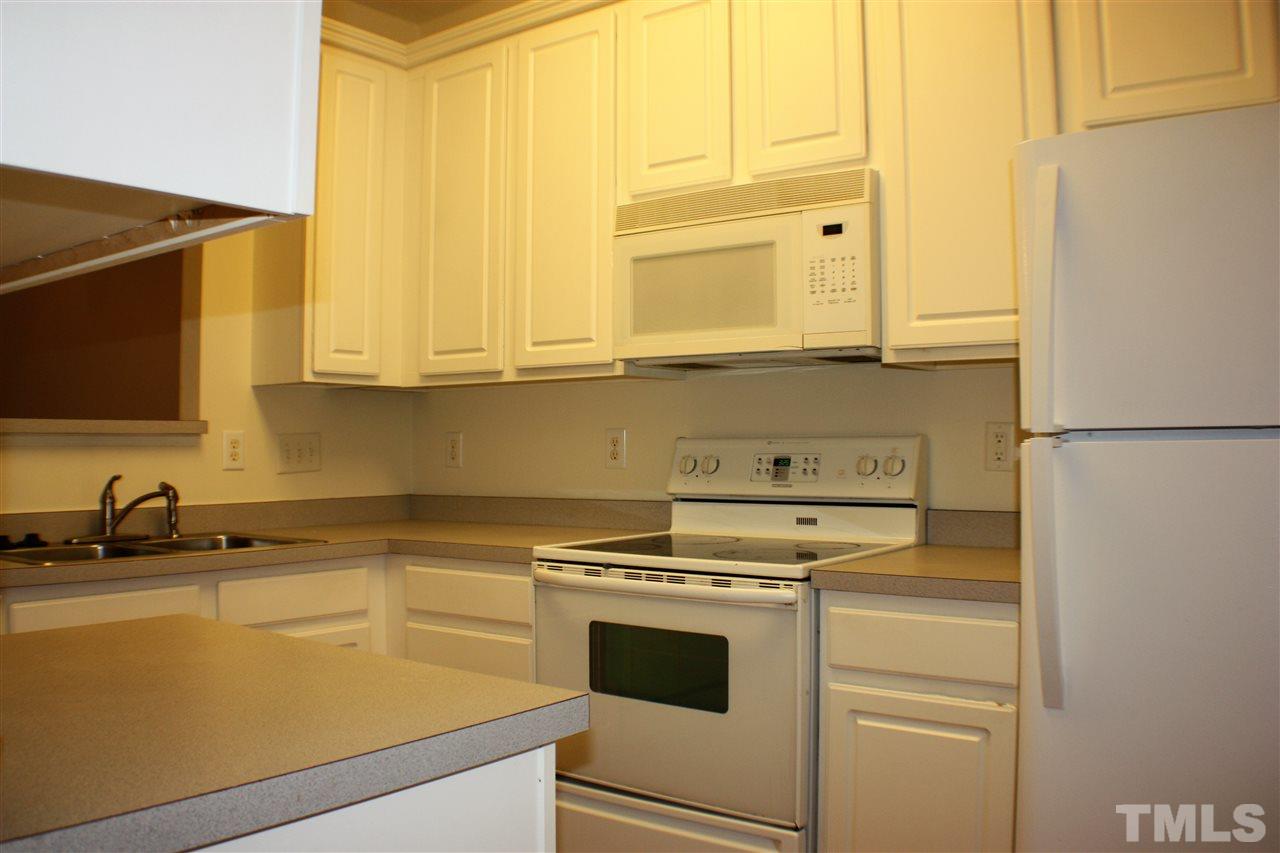 4750 Black Mountain Path Raleigh, NC 27612 - Photo 8 of 30 a kitchen with a sink and a refrigerator