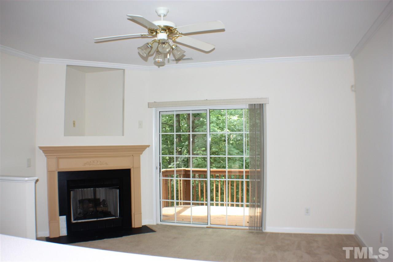 4750 Black Mountain Path Raleigh, NC 27612 - Photo 10 of 30 a living room with a fireplace and a chandelier
