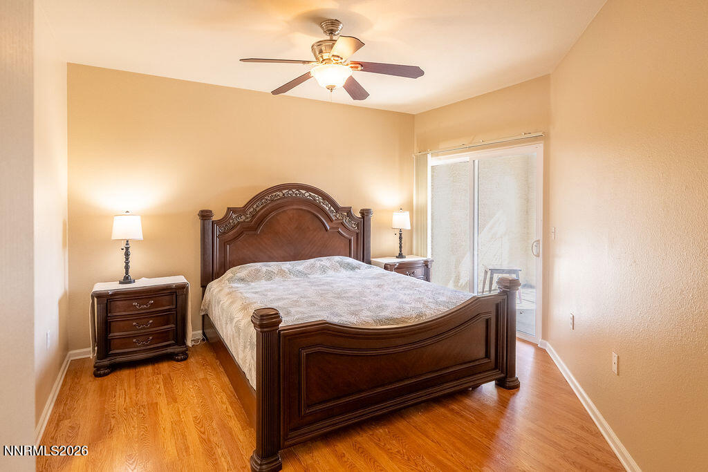9050 Double R Boulevard, Unit 212 Reno, NV 89521 - Photo 11 of 33 a bed sitting in a bedroom next to a window with a chandelier
