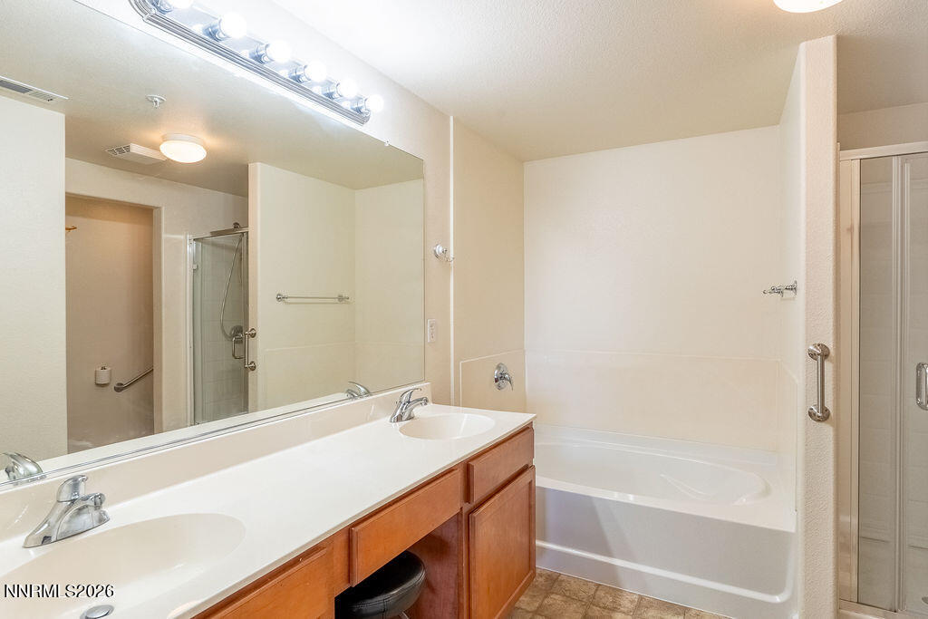 9050 Double R Boulevard, Unit 212 Reno, NV 89521 - Photo 12 of 33 a bathroom with a tub sink vanity and a mirror