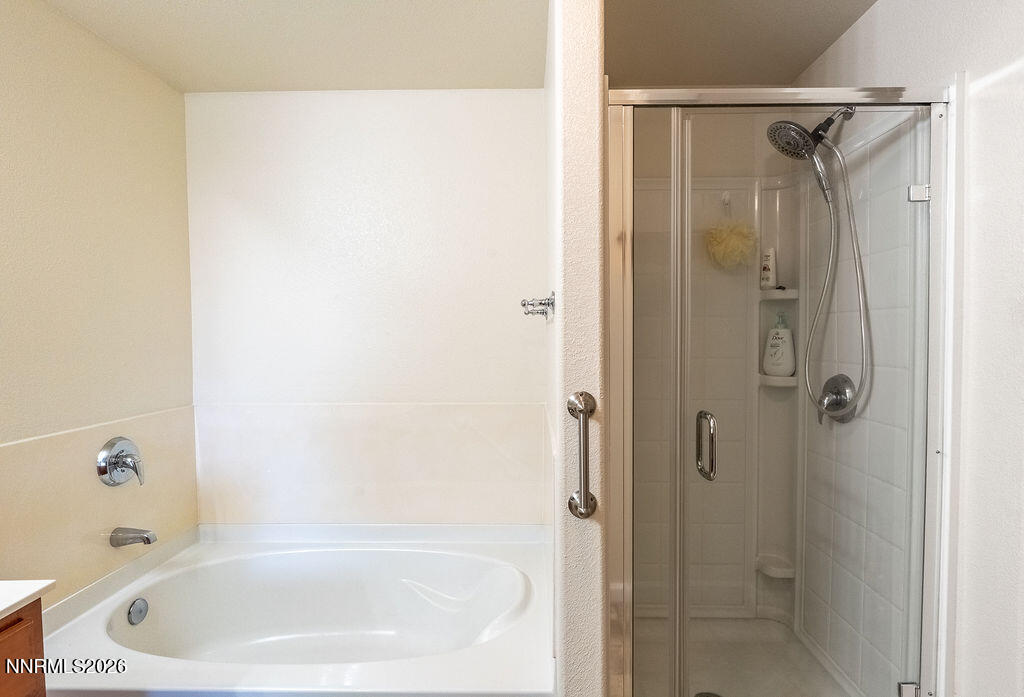 9050 Double R Boulevard, Unit 212 Reno, NV 89521 - Photo 13 of 33 a white bath tub sitting next to a shower