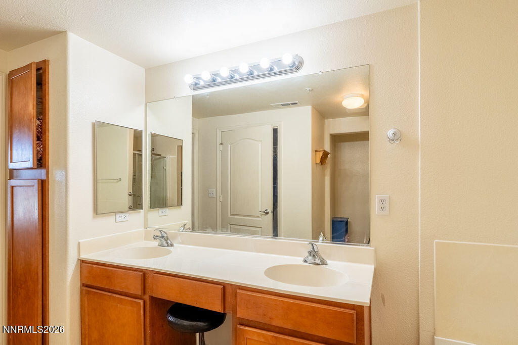 9050 Double R Boulevard, Unit 212 Reno, NV 89521 - Photo 14 of 33 a bathroom with a sink and a mirror