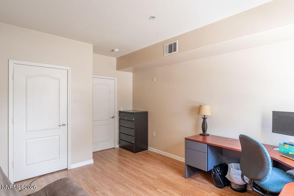9050 Double R Boulevard, Unit 212 Reno, NV 89521 - Photo 17 of 33 a view of workspace with furniture and wooden floor