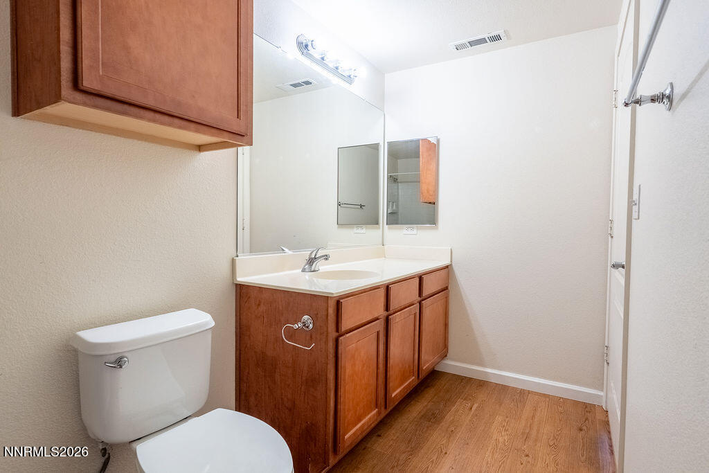 9050 Double R Boulevard, Unit 212 Reno, NV 89521 - Photo 20 of 33 a bathroom with a sink a toilet and mirror