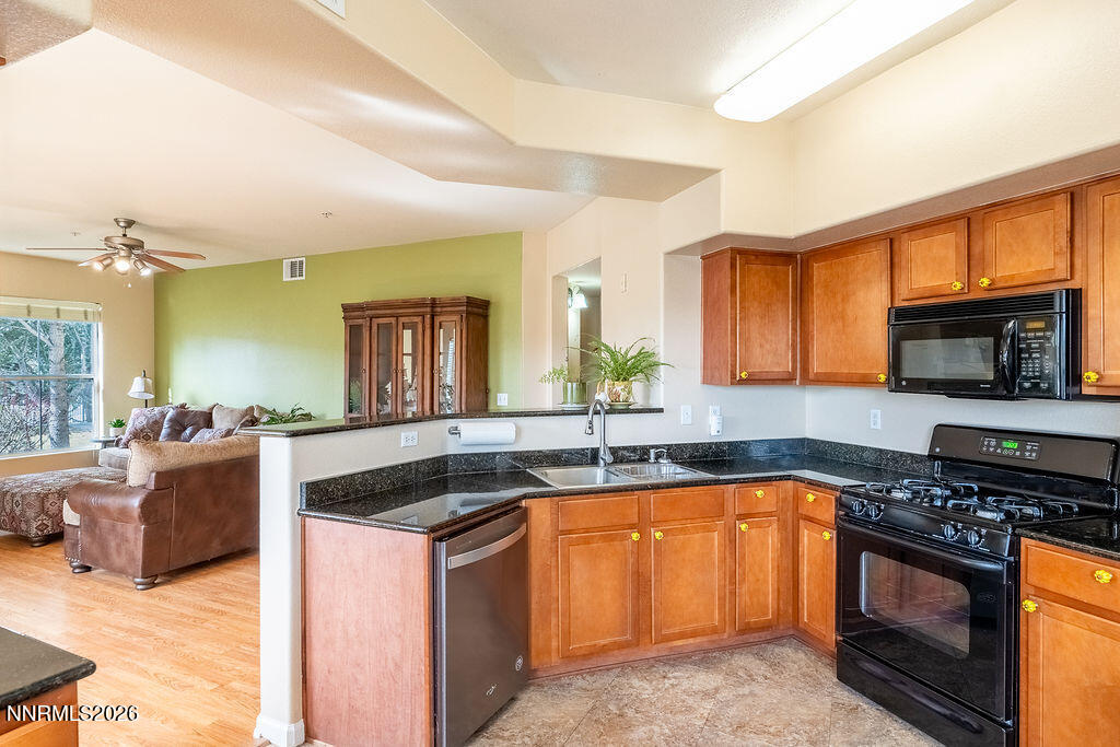 9050 Double R Boulevard, Unit 212 Reno, NV 89521 - Photo 9 of 33 a kitchen with a sink stove and microwave