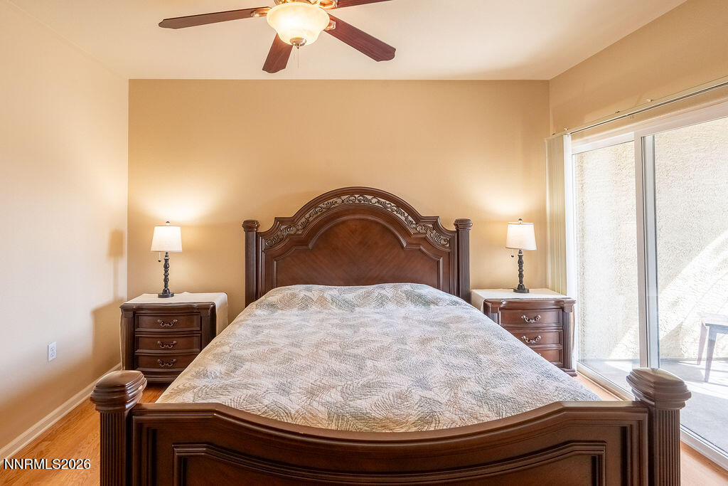 9050 Double R Boulevard, Unit 212 Reno, NV 89521 - Photo 10 of 33 a bedroom with a bed and wooden floor