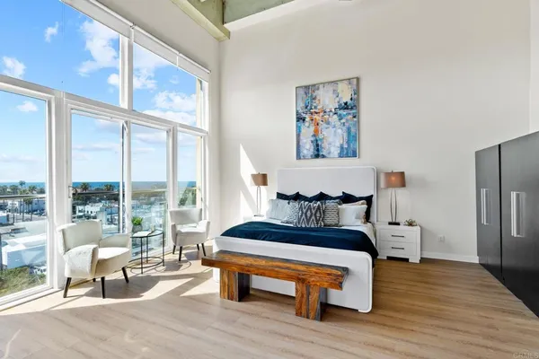 a spacious bedroom with a bed and a large window