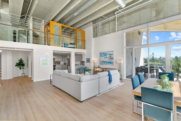a living room with furniture wooden floor and a table
