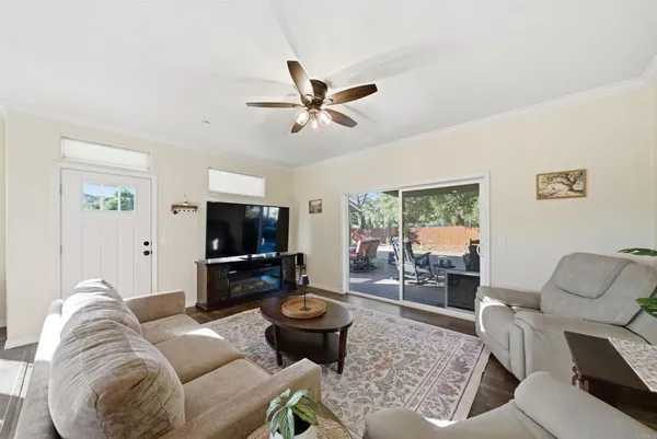 a living room with furniture and view of kitchen