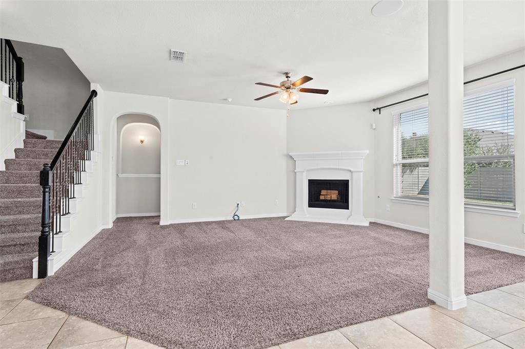 912 Falcon Road Argyle, TX 76226 - Photo 7 of 40 Family room with fireplace and ceiling fan