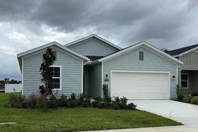a front view of house with yard and green space